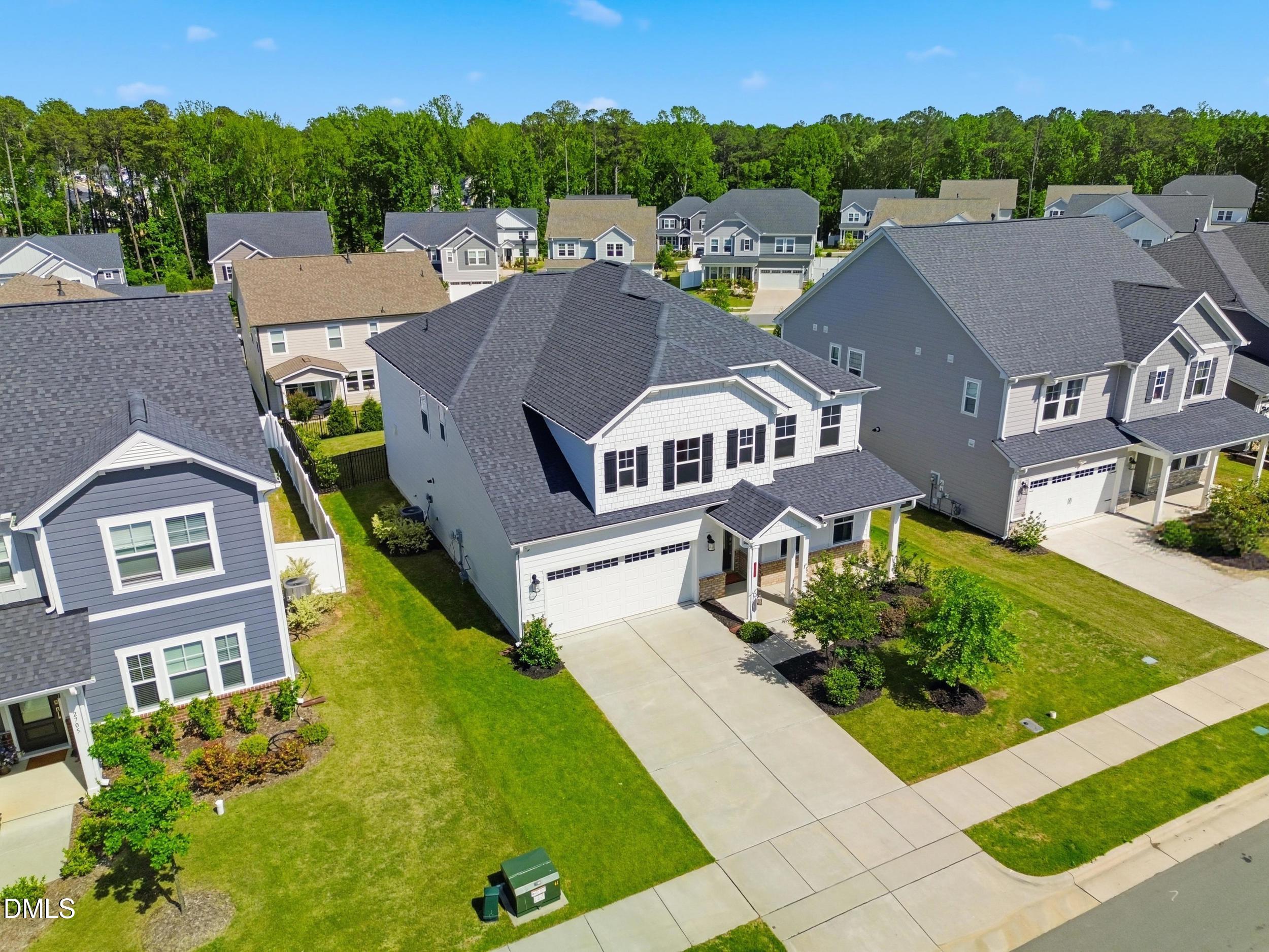 2709 Womble Ridge Drive New Hill, NC 27562 - Photo 50 of 60 an aerial view of multiple houses with a yard