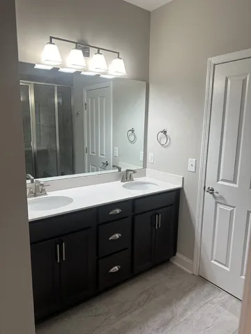 a bathroom with a glass shower door