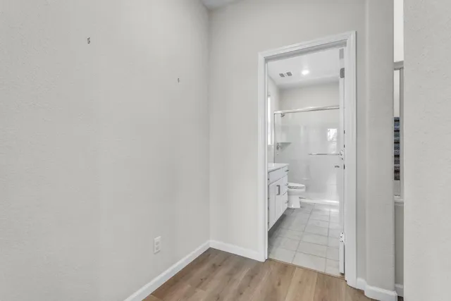 a large kitchen with stainless steel appliances kitchen island a large counter top and a stove top oven