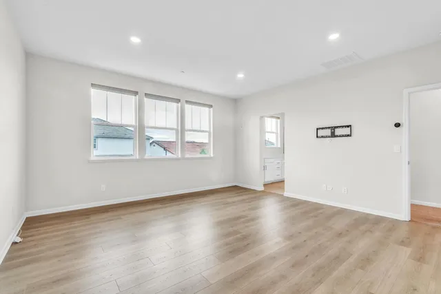 a spacious bathroom with double sink and a mirror