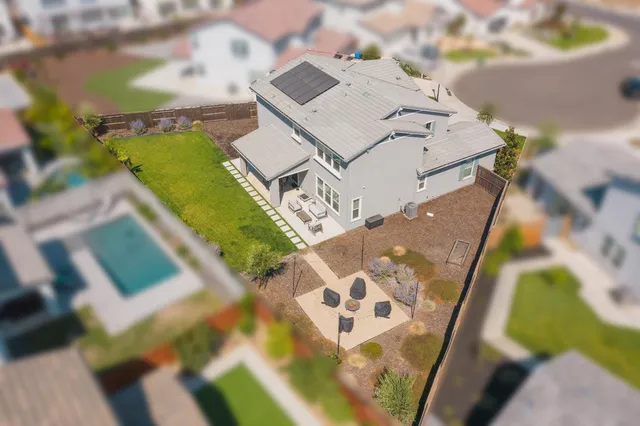 a view of a patio with a table chairs and a yard