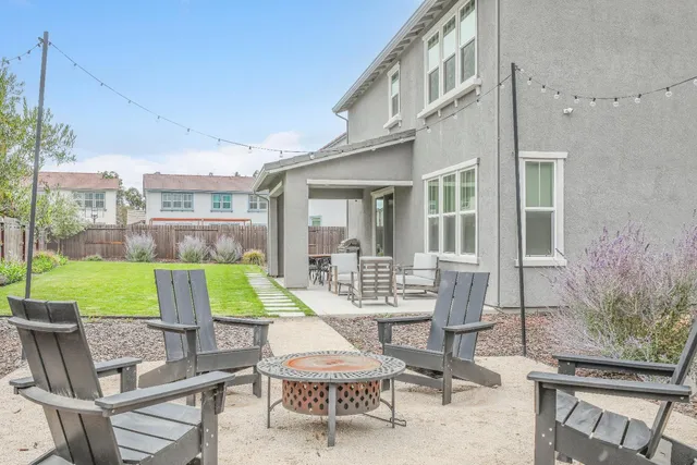 a view of a house with swimming pool and sitting area