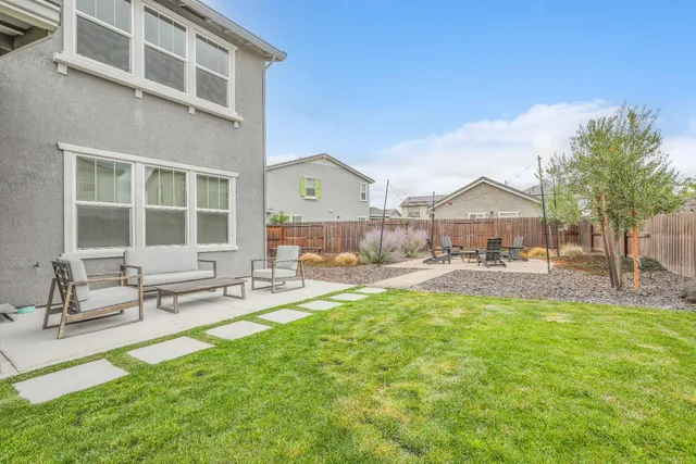 a view of a patio with a table and chairs
