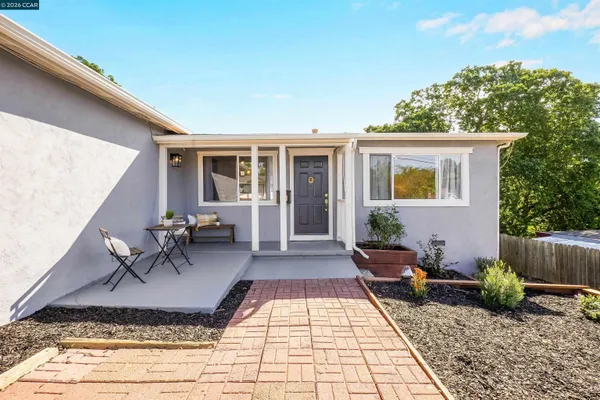 a view of a patio with chairs and a table