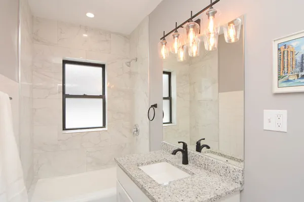a bathroom with a sink a vanity and a mirror