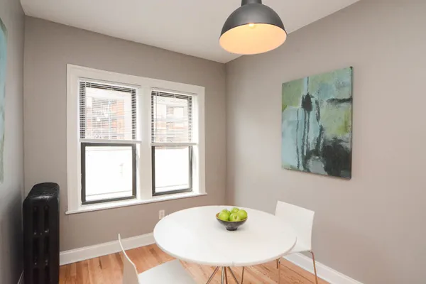 a view of a dining room with a table and chairs