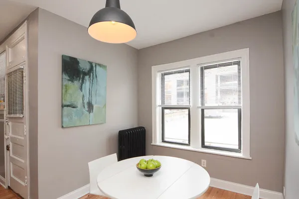 a view of a dining room with a table and chairs