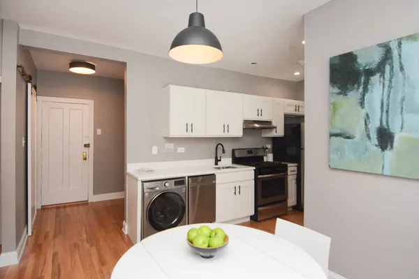 a utility room with sink washer and dryer