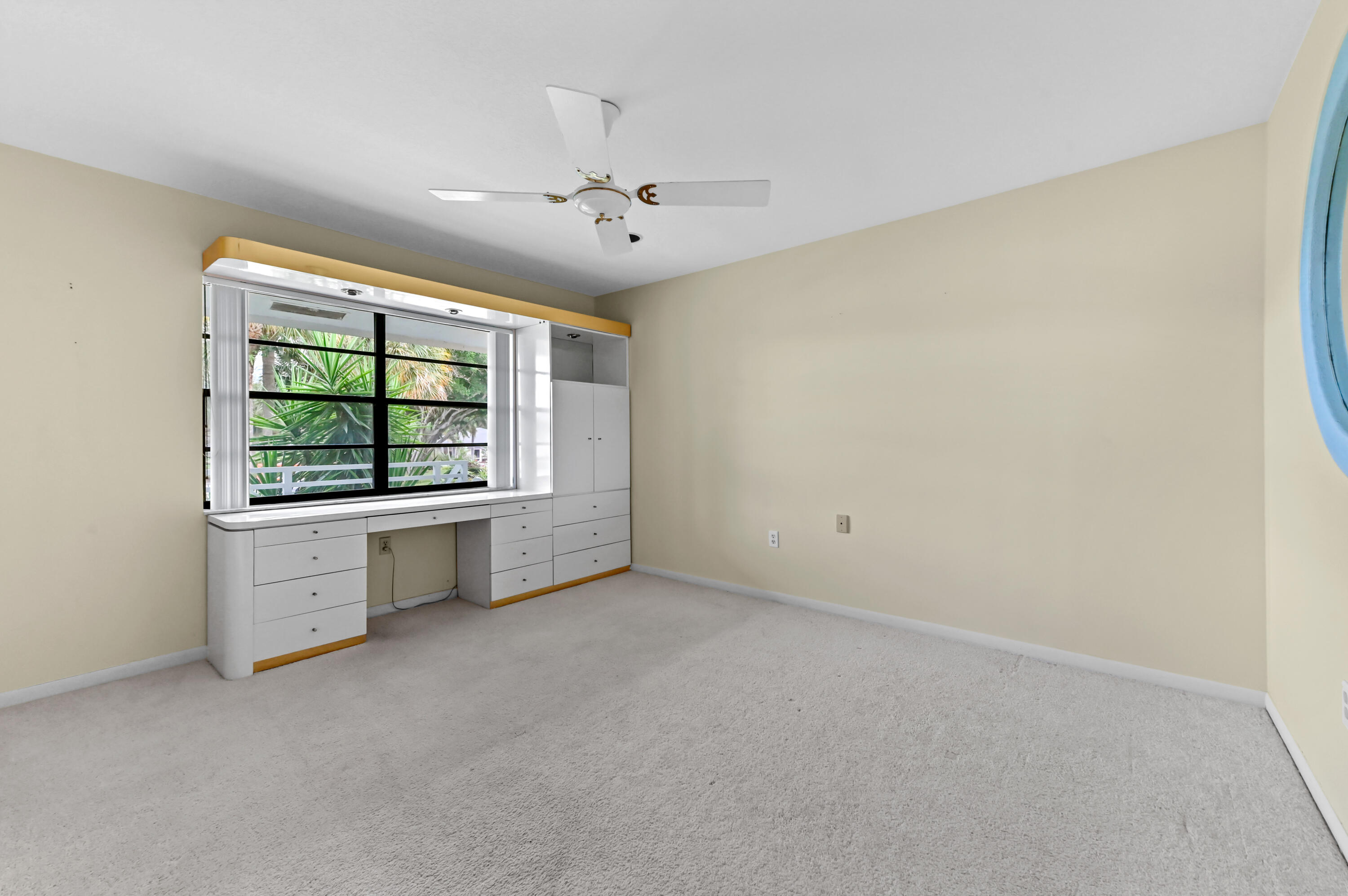 33 Southport Lane, Unit D Boynton Beach, FL 33436 - Photo 13 of 42 an empty room with windows and chandelier fan