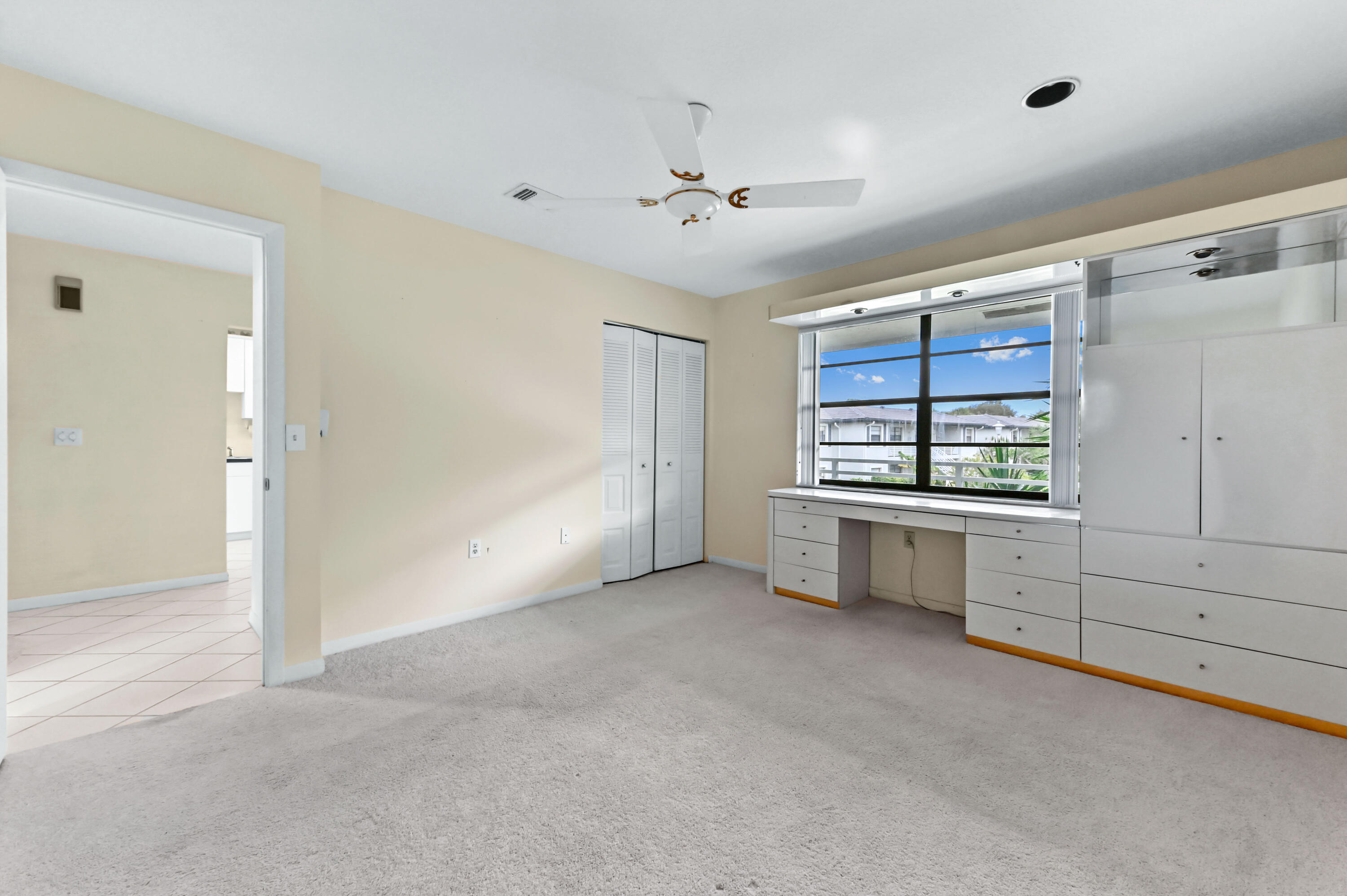 33 Southport Lane, Unit D Boynton Beach, FL 33436 - Photo 14 of 42 a view of an empty room with window and cabinet