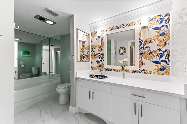 a bathroom with a sink mirror and a bathtub