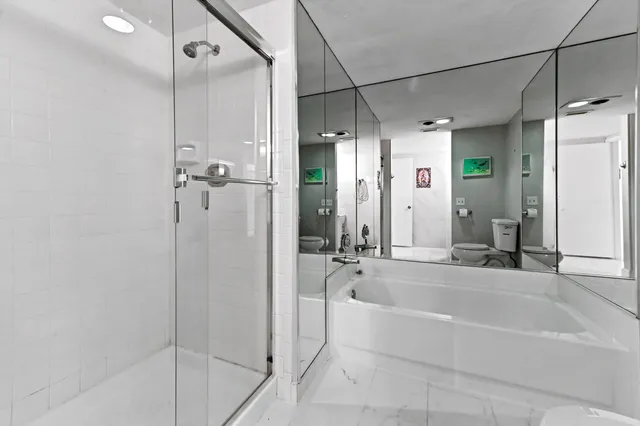 a spacious bathroom with a bathtub and a shower