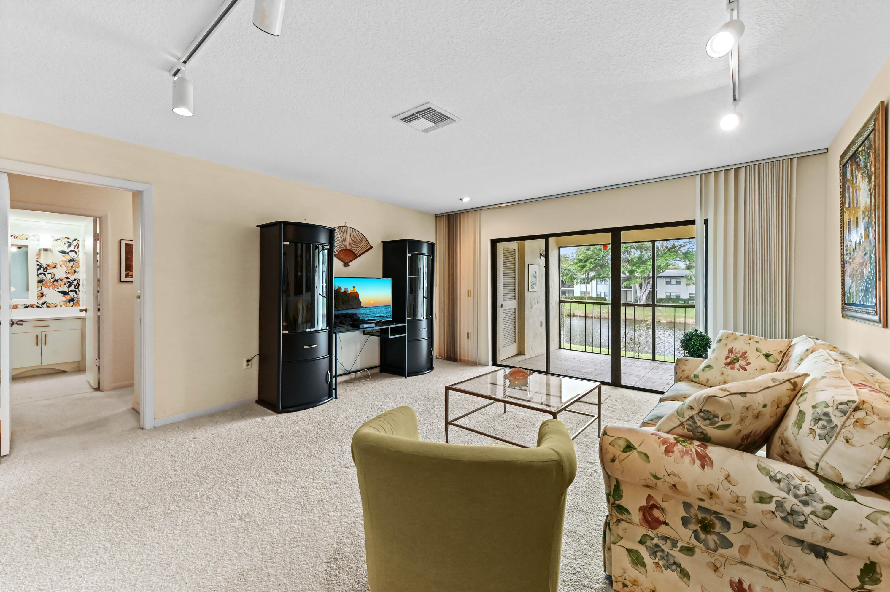 33 Southport Lane, Unit D Boynton Beach, FL 33436 - Photo 27 of 42 a living room with furniture and large windows