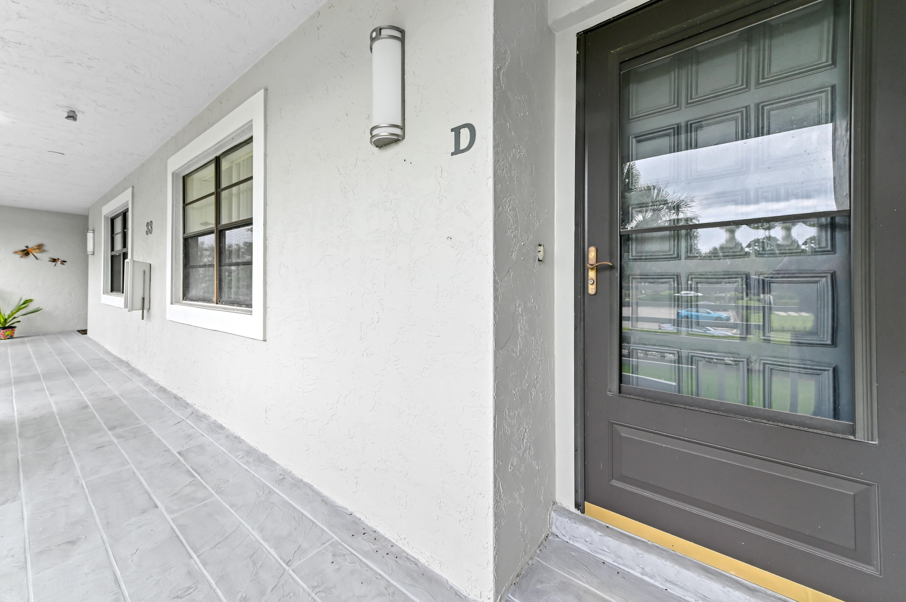 33 Southport Lane, Unit D Boynton Beach, FL 33436 - Photo 3 of 42 a view of a glass door with a glass door