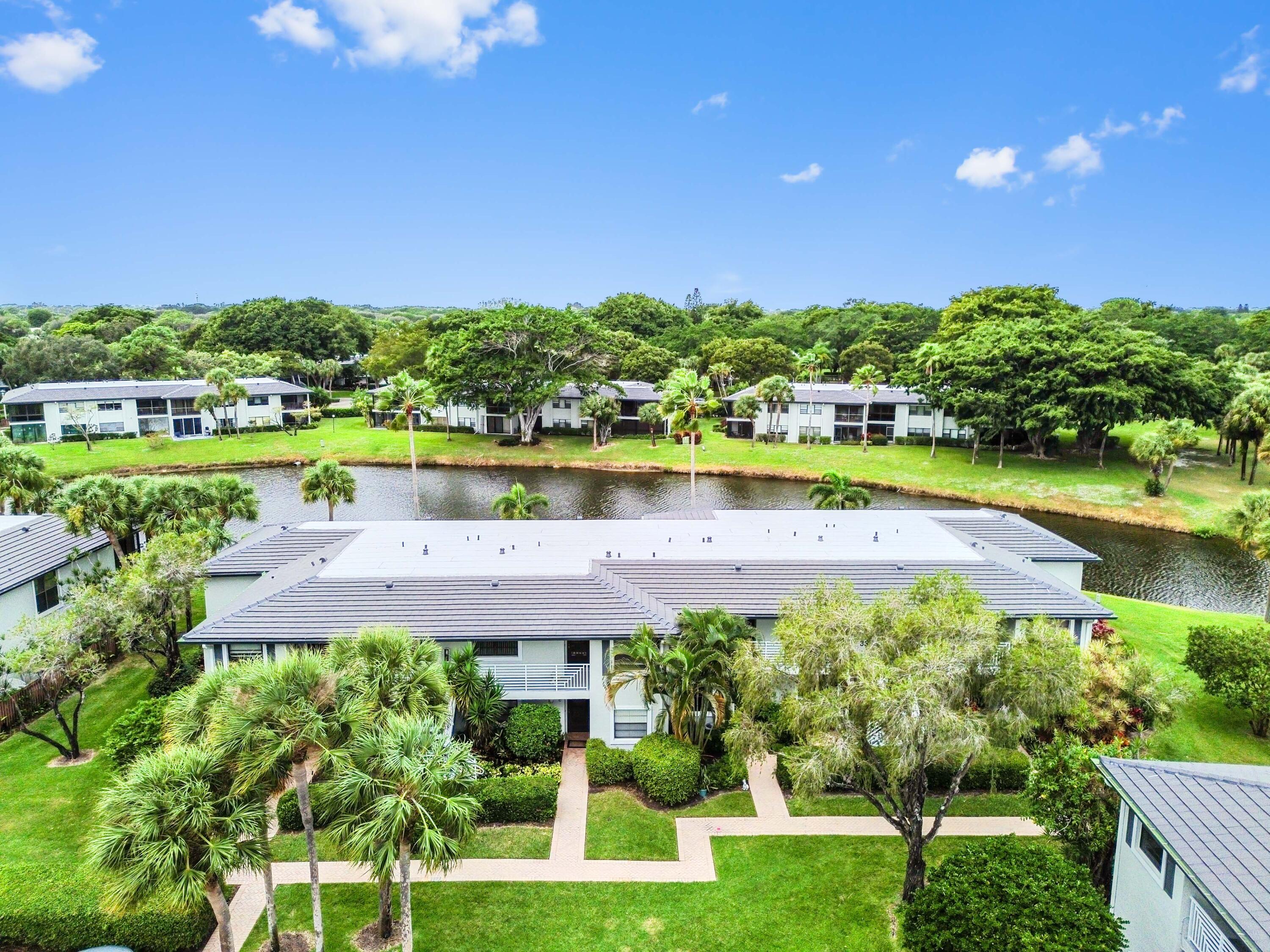 33 Southport Lane, Unit D Boynton Beach, FL 33436 - Photo 35 of 42 a view of a lake with a house in the background