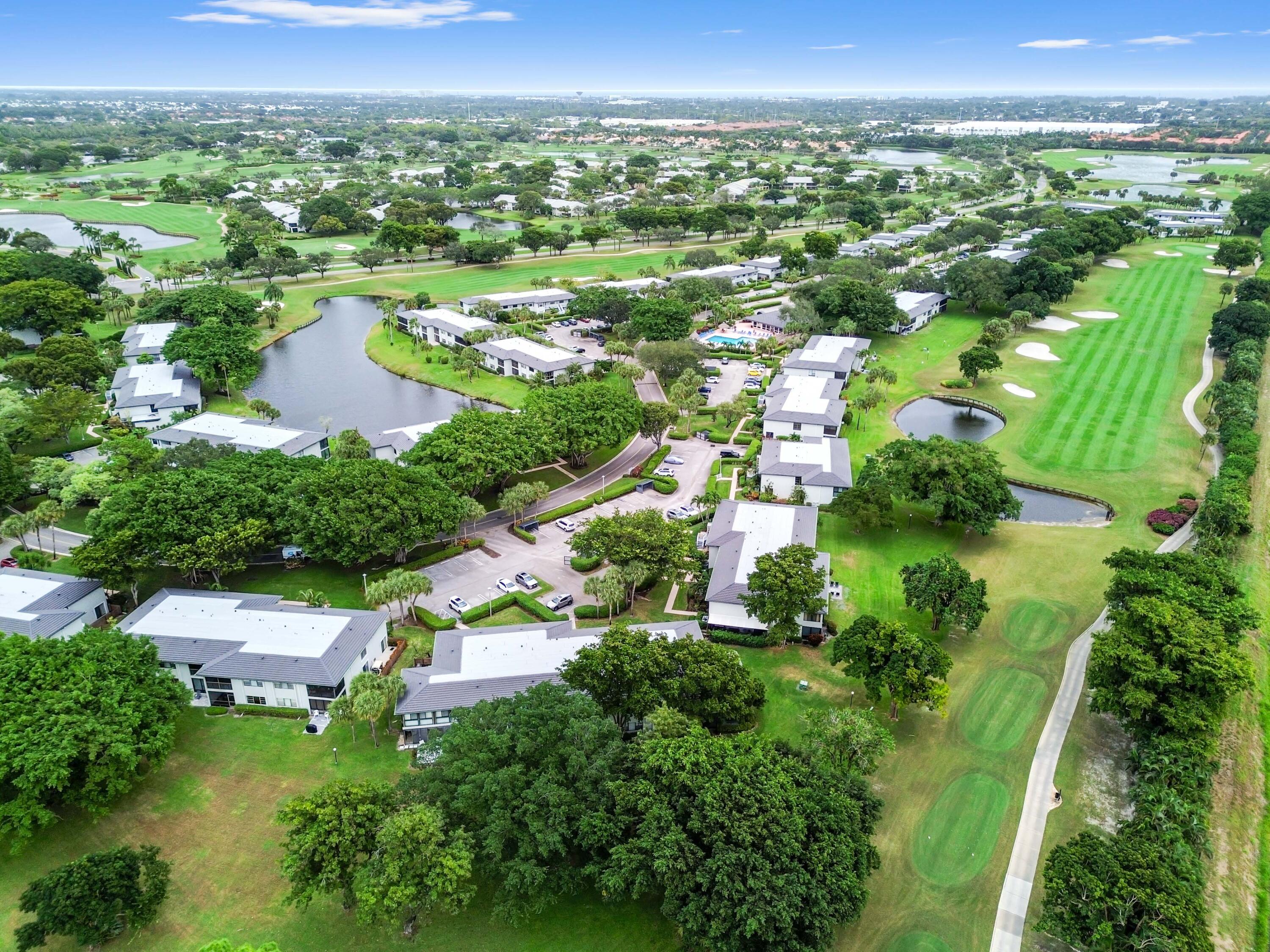 33 Southport Lane, Unit D Boynton Beach, FL 33436 - Photo 40 of 42 an aerial view of residential houses with outdoor space and trees