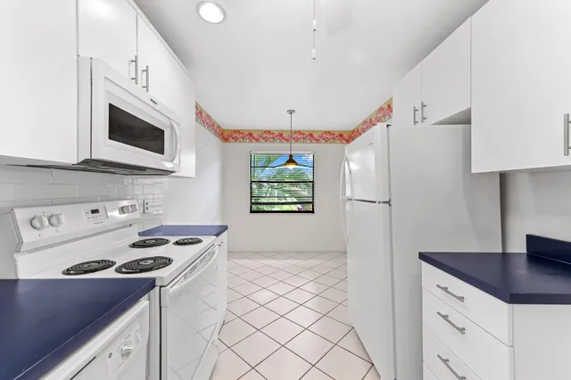 a kitchen with stainless steel appliances a stove a sink and a refrigerator