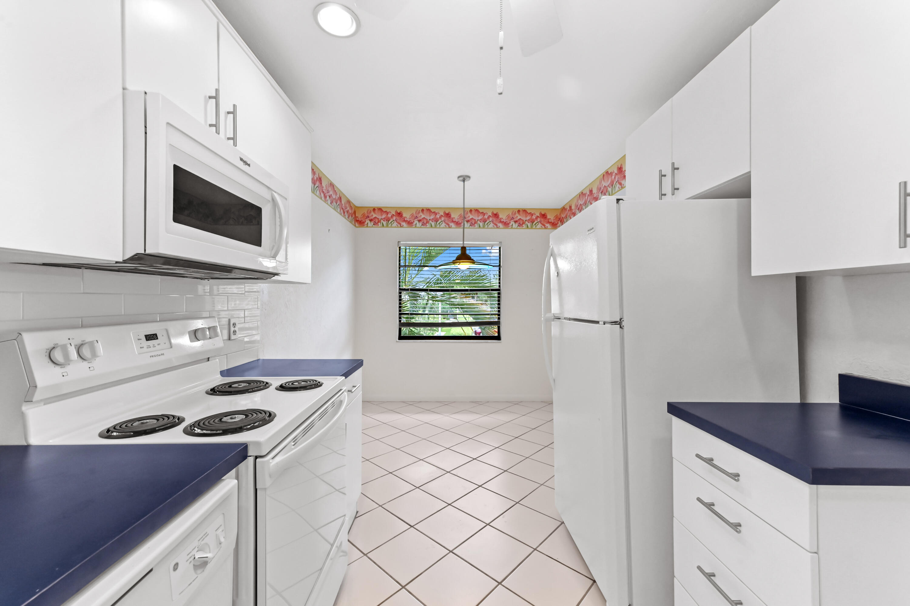 33 Southport Lane, Unit D Boynton Beach, FL 33436 - Photo 7 of 42 a kitchen with stainless steel appliances a stove a sink and a refrigerator