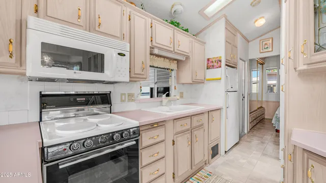 a kitchen with cabinets and a refrigerator