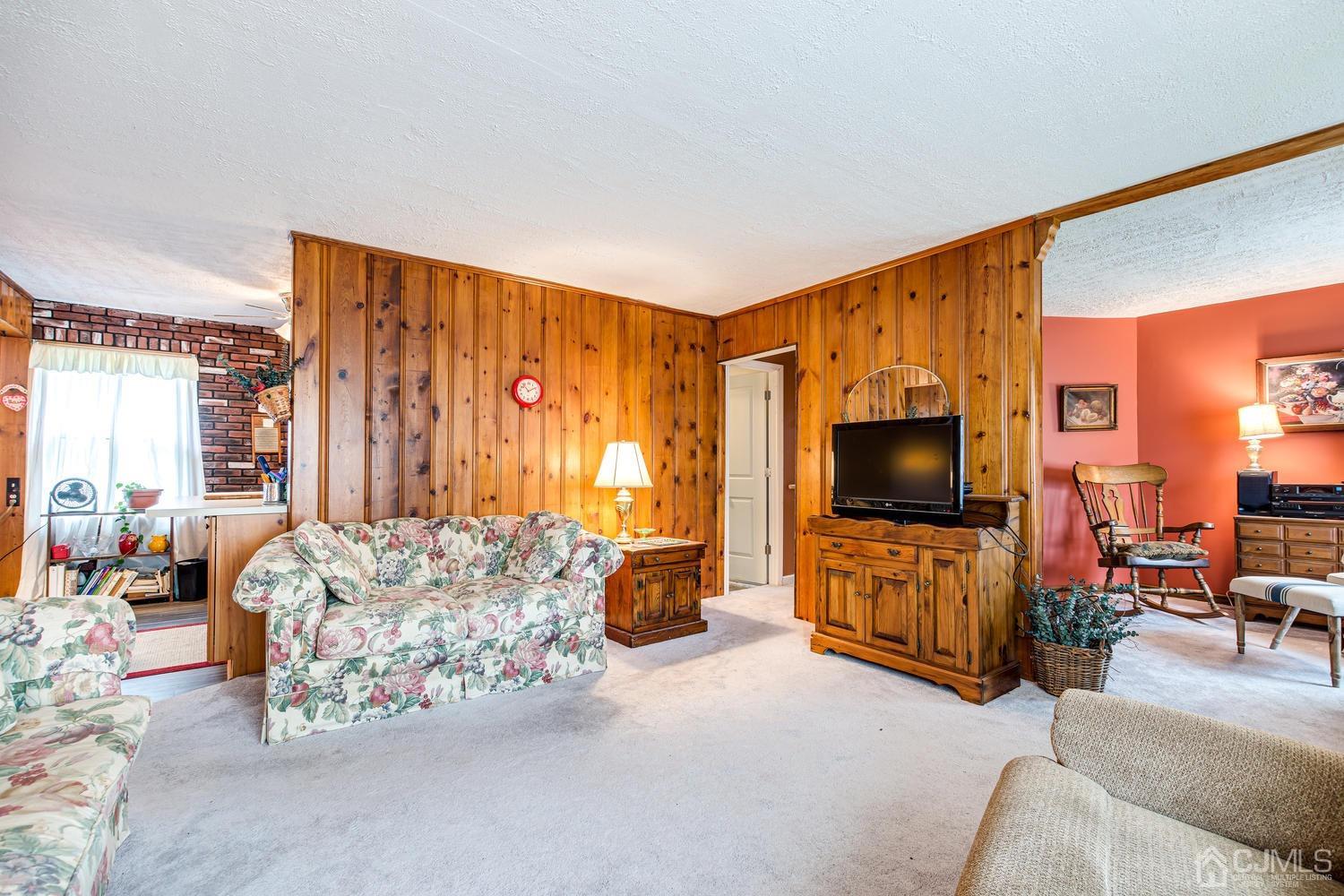 20 Parkerson Road Edison, NJ 08817 - Photo 8 of 26 a living room with furniture and a flat screen tv