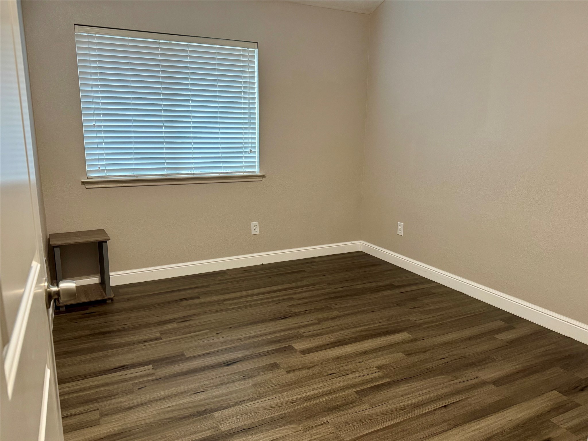 9431 Water Edge Point Lane Humble, TX 77396 - Photo 12 of 16 a view of a room with wooden floor and a window