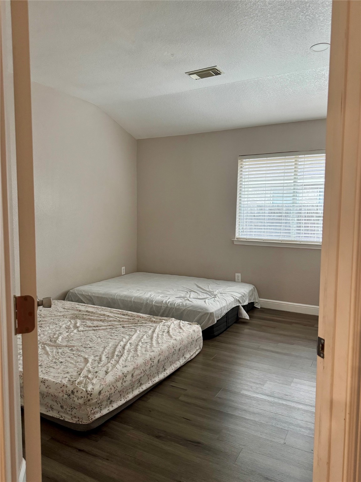 9431 Water Edge Point Lane Humble, TX 77396 - Photo 13 of 16 a bedroom with bed and wooden floor