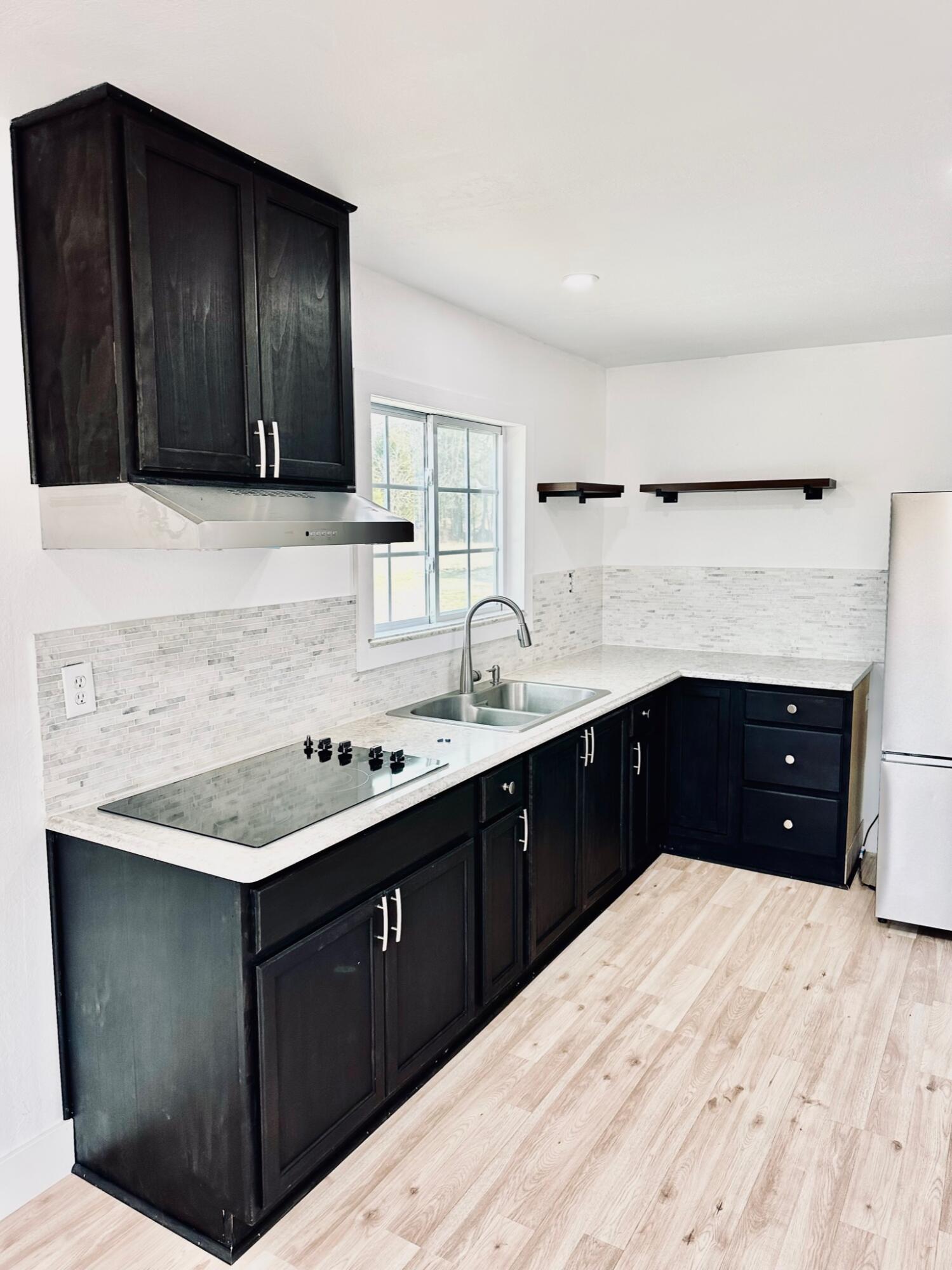 2514 Greensboro Road Washington, GA 30673 - Photo 9 of 36 solid countertop with tile backsplash