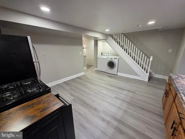 a room with wooden floor and gym equipment