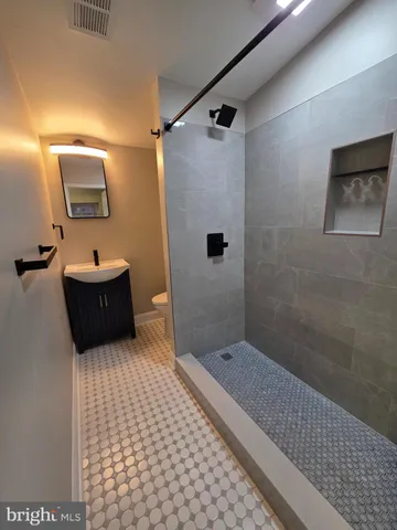 a bathroom with a sink a shower and a mirror