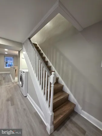 a view of entryway and hall with wooden floor
