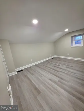 a view of room with wooden floor and window