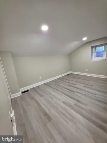a view of room with wooden floor and window