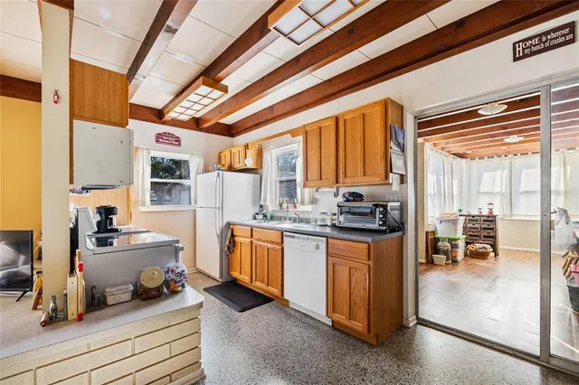 a kitchen with stainless steel appliances granite countertop a stove and a refrigerator
