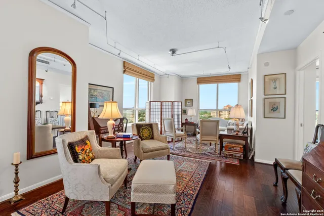 a living room with fireplace furniture and wooden floor