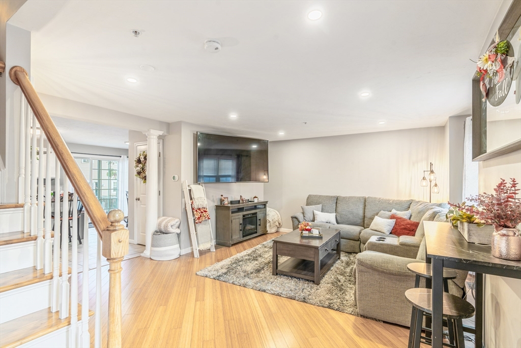 1975 Middlesex Street, Unit 2 Lowell, MA 01851 - Photo 13 of 31 a living room with furniture flat screen tv and a large window