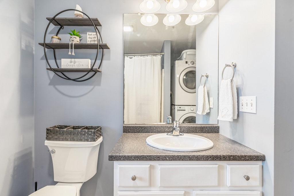 1975 Middlesex Street, Unit 2 Lowell, MA 01851 - Photo 20 of 31 a bathroom with a granite countertop toilet a sink and a mirror