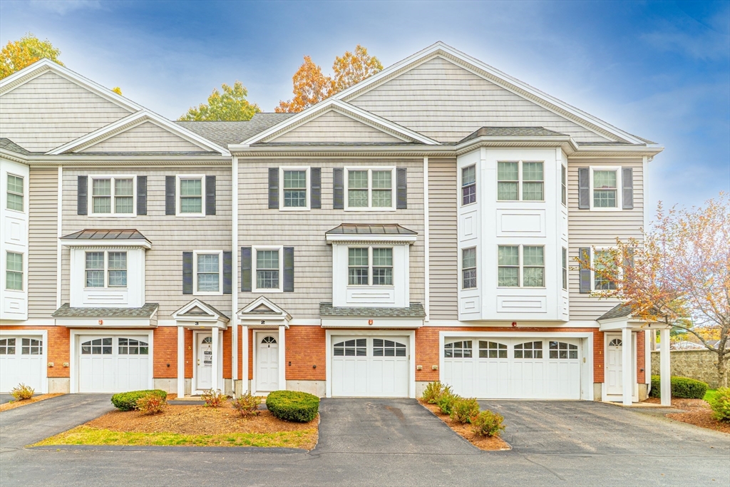 1975 Middlesex Street, Unit 2 Lowell, MA 01851 - Photo 3 of 31 a front view of a residential apartment building with a yard