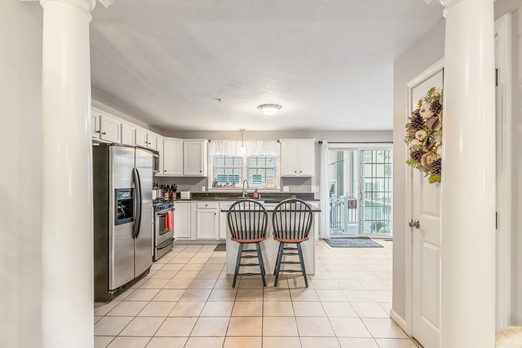 1975 Middlesex Street, Unit 2 Lowell, MA 01851 - Photo 9 of 31 a dining room with furniture and a floor to ceiling window