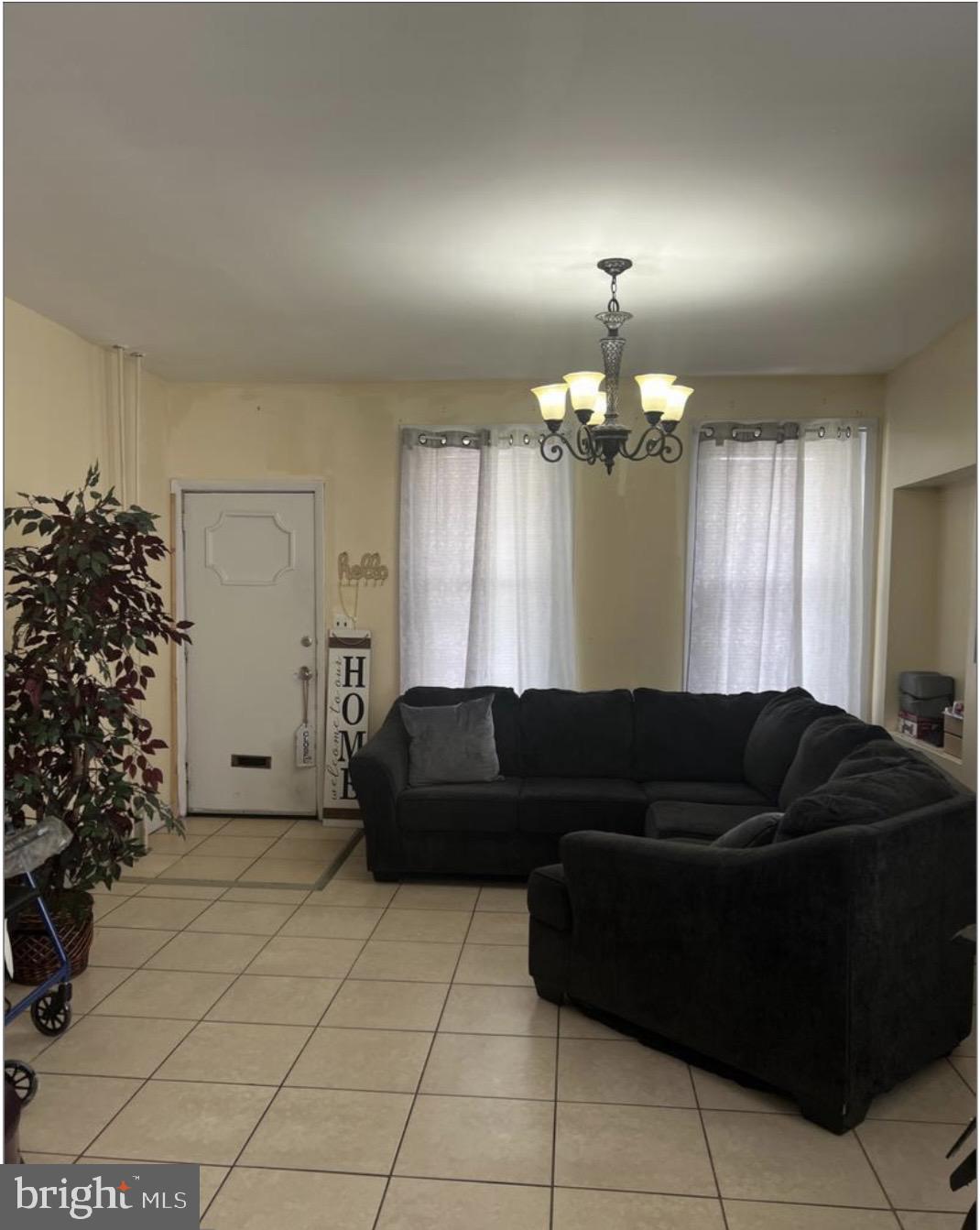 6700 Marsden Street Philadelphia, PA 19135 - Photo 2 of 7 a living room with furniture and a chandelier