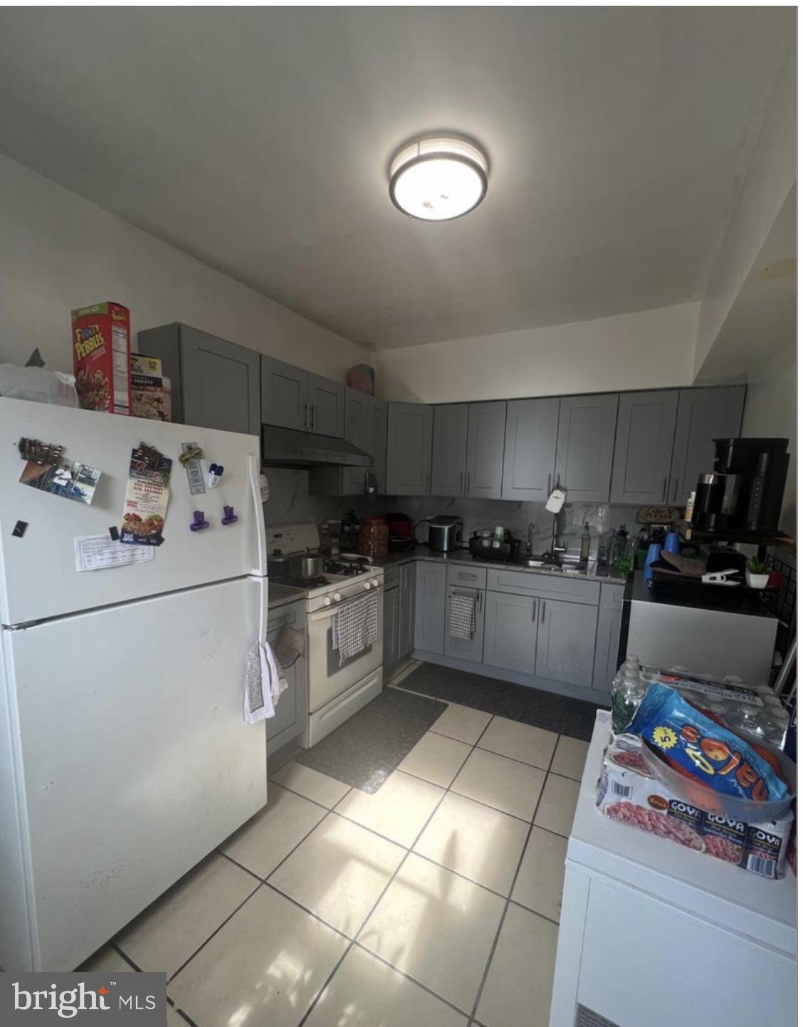 6700 Marsden Street Philadelphia, PA 19135 - Photo 5 of 7 a kitchen with a cabinets and white appliances