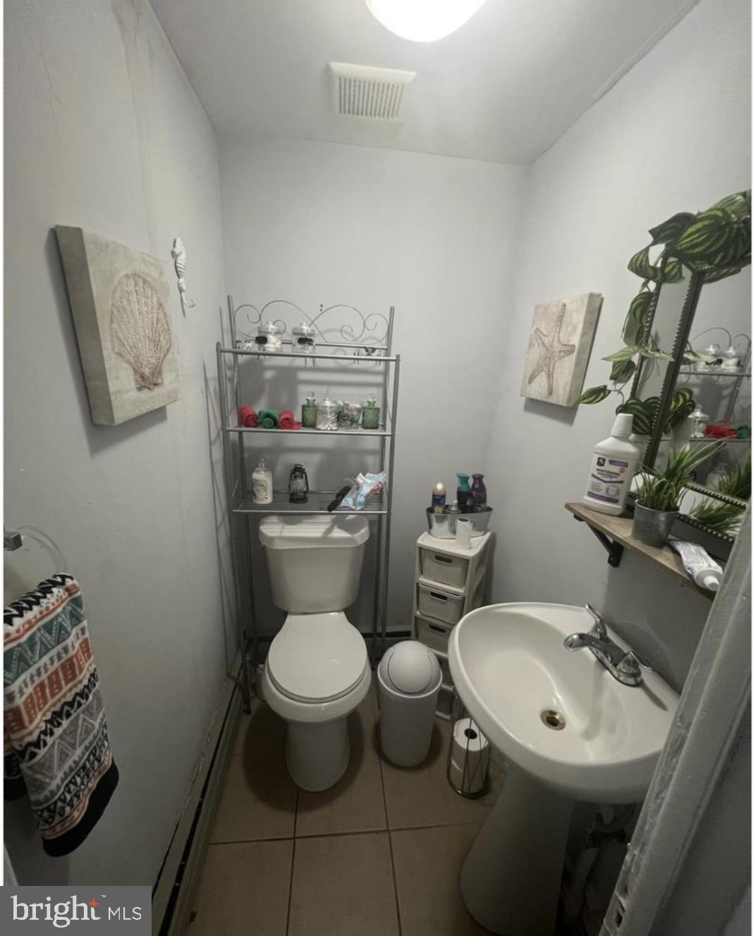 6700 Marsden Street Philadelphia, PA 19135 - Photo 6 of 7 a bathroom with a toilet sink and mirror