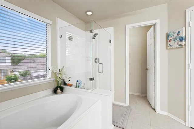 a bathroom with a tub shower and a sink