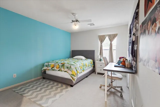 a bedroom with a bed and a table in it