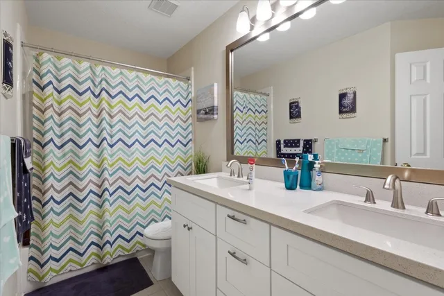 a bathroom with a sink a vanity and a shower