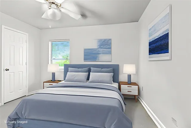 a bedroom with bed and a chandelier