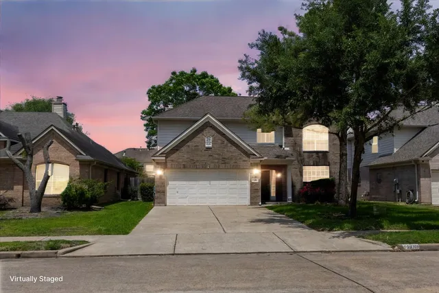a front view of a house with a yard and a garage