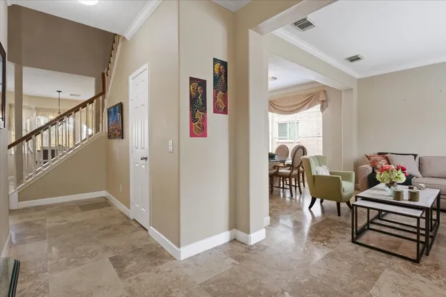 a living room with furniture and a dining table