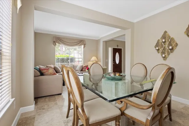 a view of a dining room with furniture and window