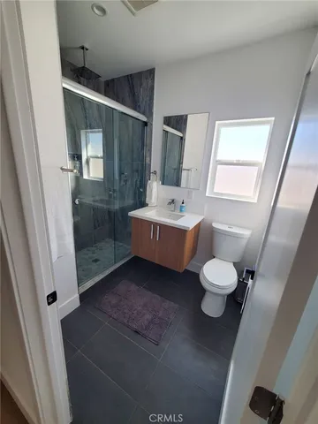 a bathroom with a sink mirror and toilet