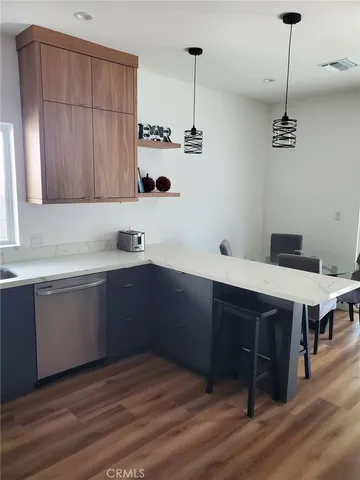 a kitchen with stainless steel appliances granite countertop a sink a microwave cabinets and wooden floor